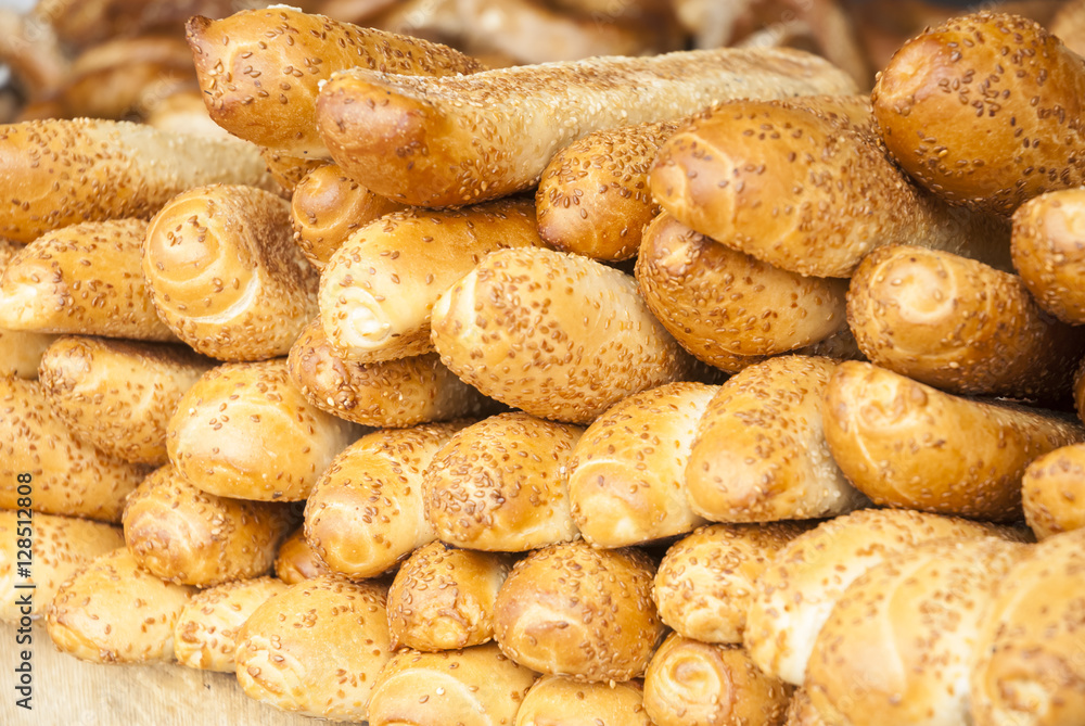 Wheaten long loafs. Traditional baked white bread with seeds. Freshly baked bread in the Eastern markets(selective focus) Wheaten long loafs. Traditional baked white bread with seeds. Freshly baked bread in the Eastern markets(selective focus)