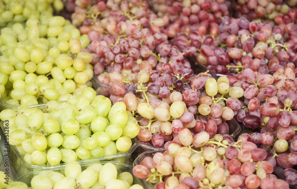 Grape. Wine grapes background. Grapes an market. It can be used as a food background (selective focus) Grape. Wine grapes background. Grapes an market. It can be used as a food background (selective focus)