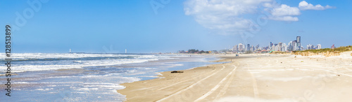 Panorama of Torres beach with lighthouses and city buildings