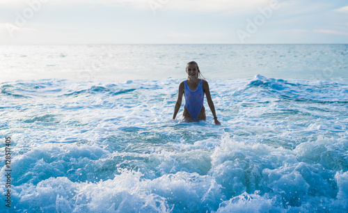 Woman wearing white swimsuit smiling  in sea water. Summertime concept © stryjek