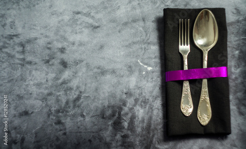 Rustic vintage set of cutlery spoon, fork. Dark background. Top view