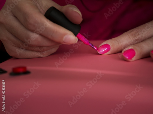 Female manicuring her own nails.
