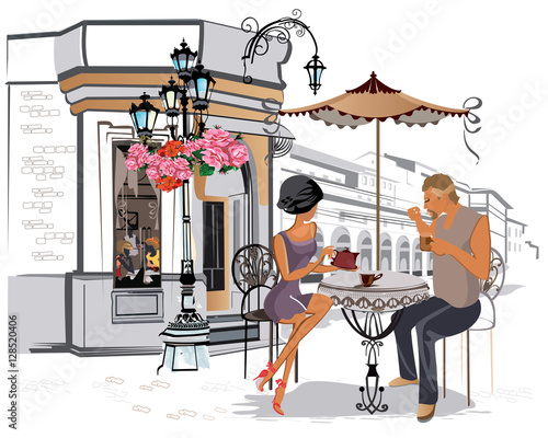 Fashion girls in the street cafe. Street cafe with flowers in the old city. Waiters serve the tables.
