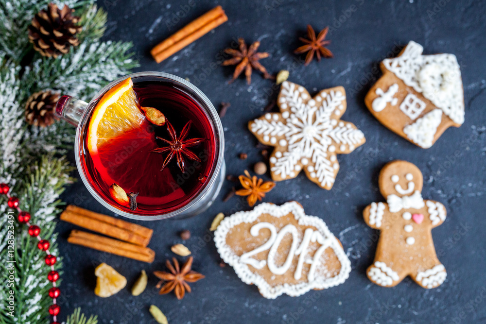Fototapeta premium Christmas mulled wine with spices in cup on dark background