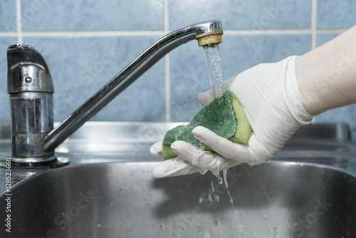 Washung sponge in the sink