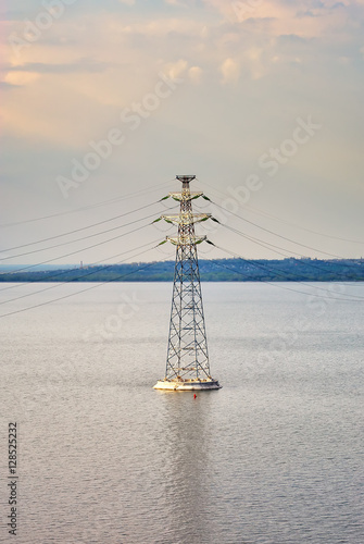 high-voltage line. High voltage electric tower on river