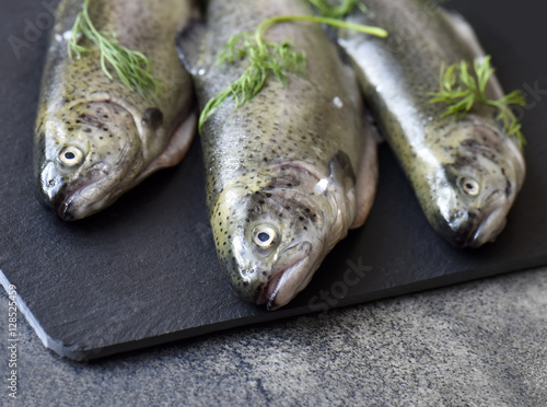 Raw trouts on gray board ready for cooking