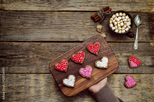 Male hands holding cookie in the forms of heart