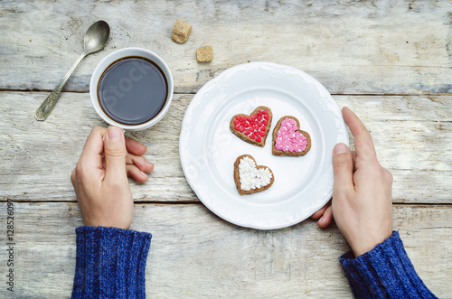 Male hands holding cookie in the forms of heart