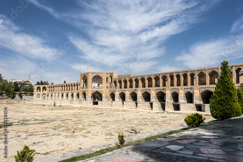 Iran, Isfahan, Pol-e Khaju: Panoramic view of the Khajoo Bridge with dried river bed. The bridge has 23 arches, is 133 meters long, 12 meters wide.