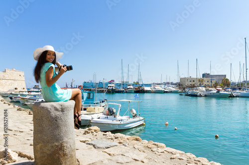 Happy tourist girl on holiday trip to Heraklion, Crete, Greece. photo