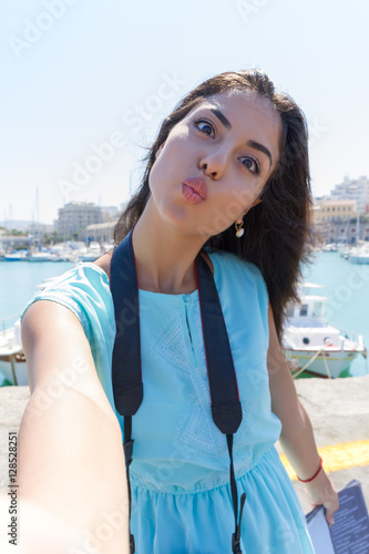 Cute happy smiling tourist girl taking self-portrait picture Heraklion Crete.