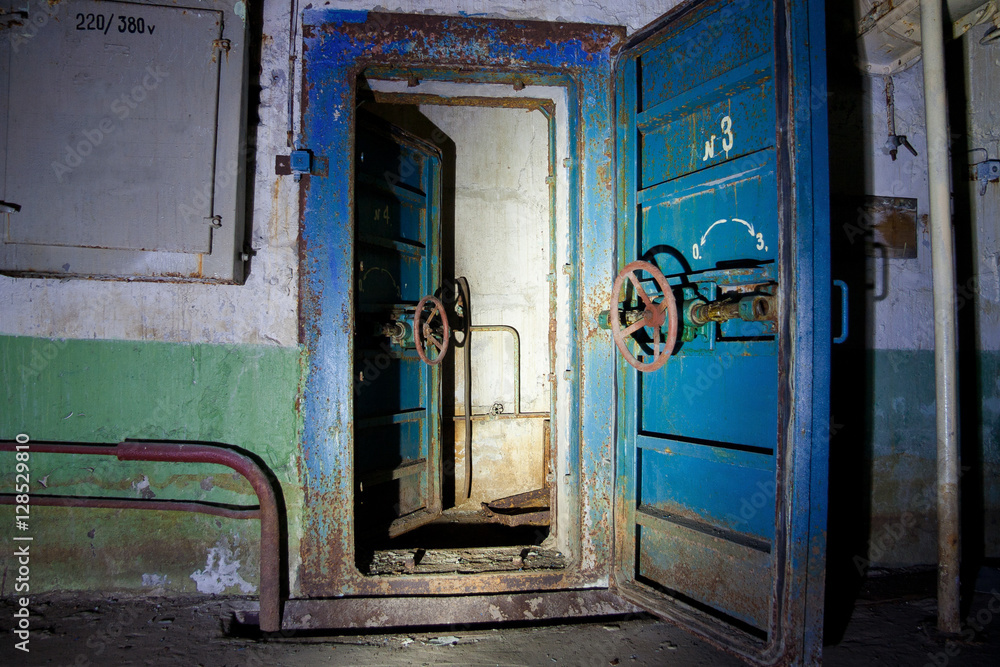 Blue rusty hermetical door of old abandoned Soviet bomb shelter Stock