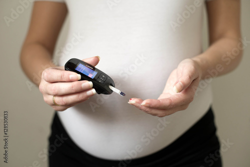 Diabetes test. Pregnant women checking sugar level with glucometer.Gestational diabetes.