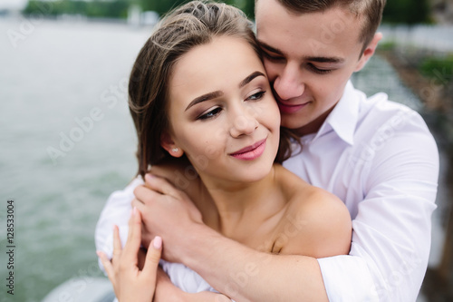 man and woman posing on the lake
