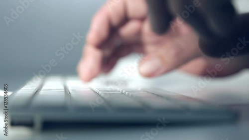 Man typing on a computer keyboard