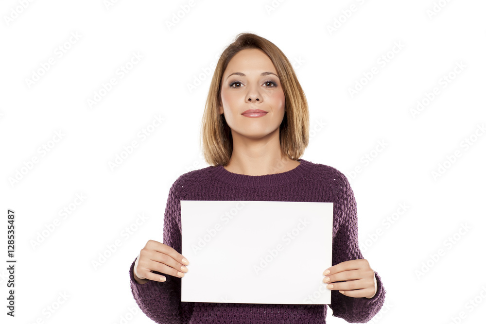 young smiling woman holding a blank sheet of paper for advertising young smiling woman holding a blank sheet of paper for advertising