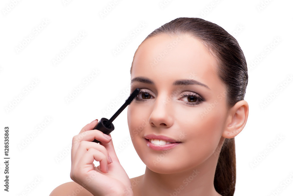 Woman brushing eyelashes isolated on white Woman brushing eyelashes isolated on white