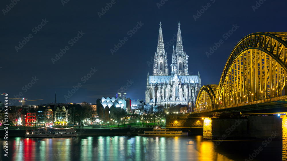 Cologne Dom and railway bridge at night.
