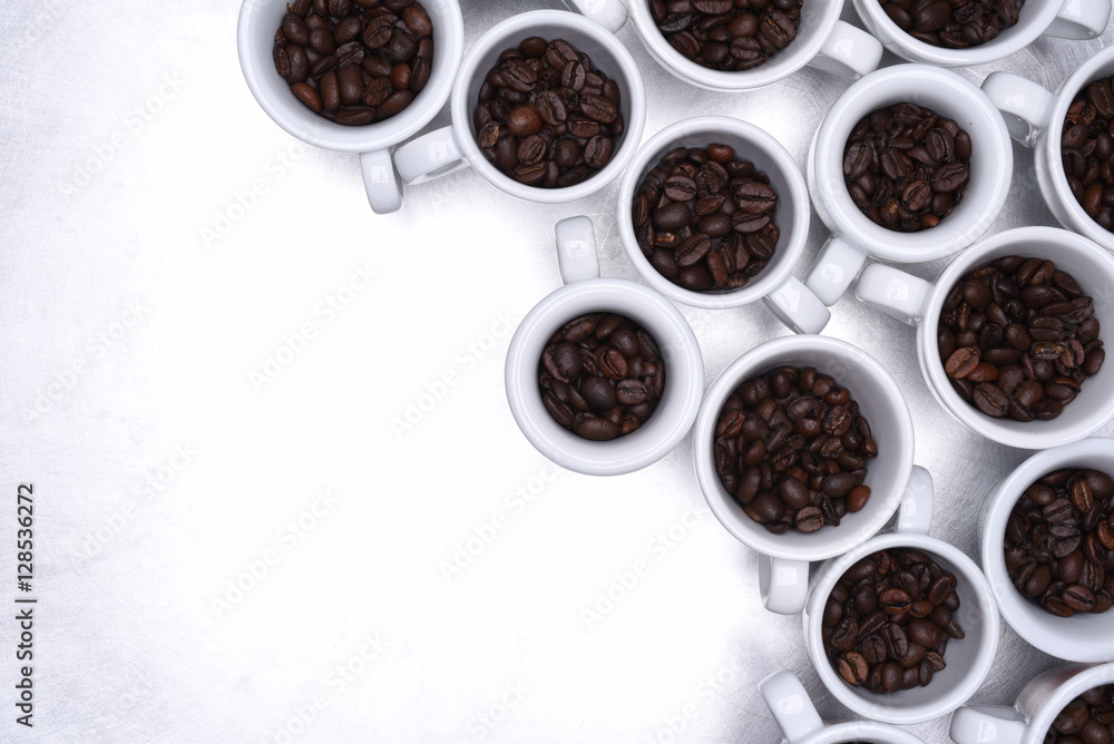 Group of coffee cup with roasted beans top view on metallic grey background Group of coffee cup with roasted beans top view on metallic grey background
