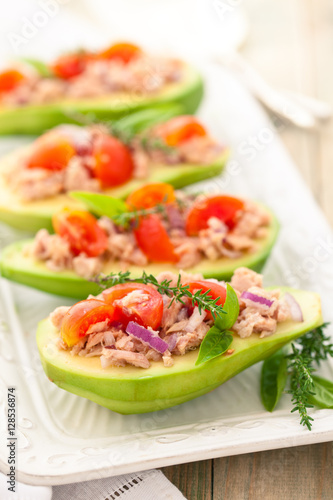 Stuffed avocado on tray.