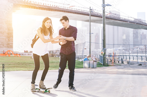 Playful couple on the skateboard in New york city