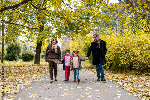 Grandparents with grandchildren in autumn park