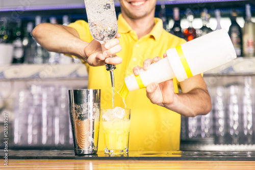 Bartender mixing a cocktail with american free pouring style photo