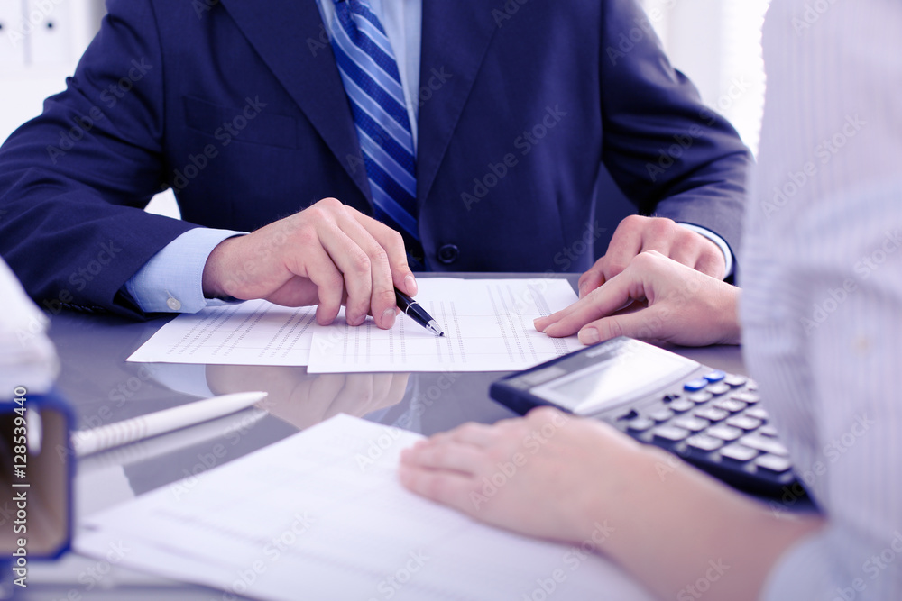 Bookkeepers or financial inspector making report, calculating or checking balance. Audit concept. Bookkeepers or financial inspector making report, calculating or checking balance. Audit concept.