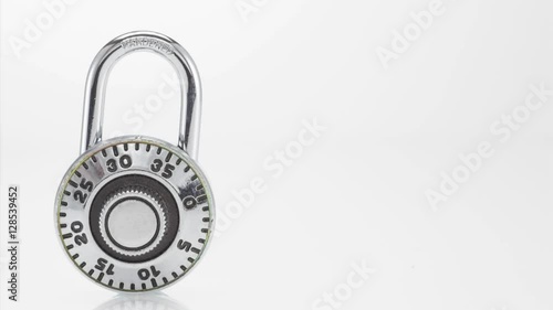 Combination lock opening on white background photo