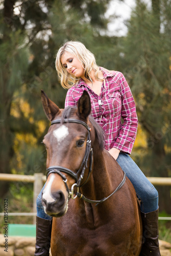 Beautiful elegance back woman cowgirl, riding a horse wearing bl