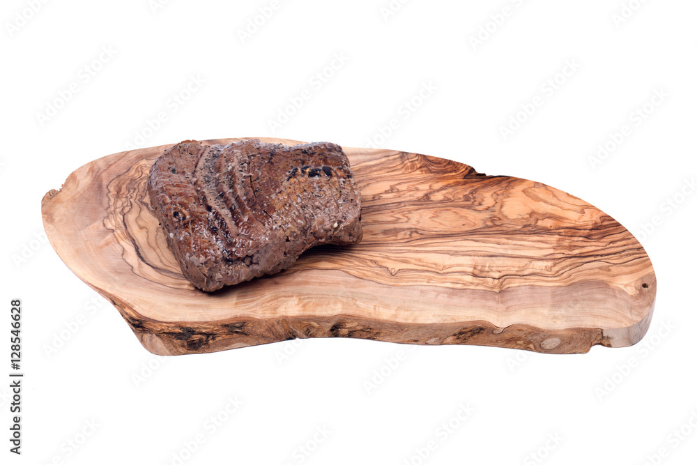 Grass fed juicy corn roast beef on olive wood cutting board isolated on white background Grass fed juicy corn roast beef on olive wood cutting board isolated on white background