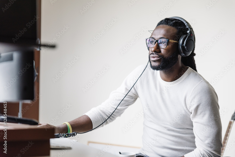 © santypan - Artist producing music in his home sound studio.