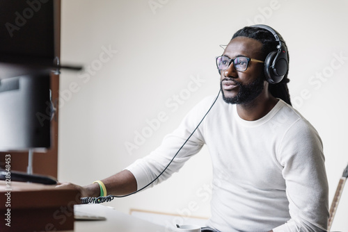 Принти на полотні Artist producing music in his home sound studio.