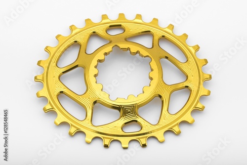 Golden oval chainring detail, close up  	