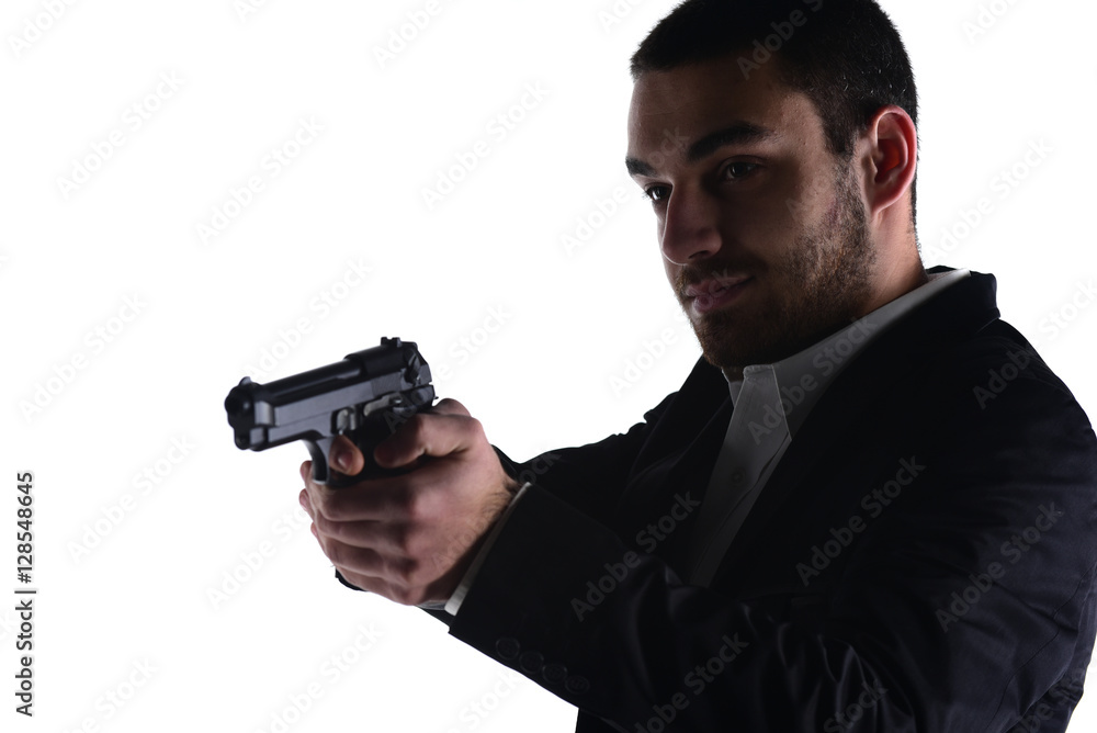 Attractive male holding gun in his hand. Assassin. Police officer. isolated on white Attractive male holding gun in his hand. Assassin. Police officer. isolated on white