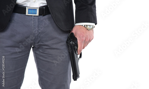  Attractive male holding gun in his hand. Assassin. Police officer. isolated on white