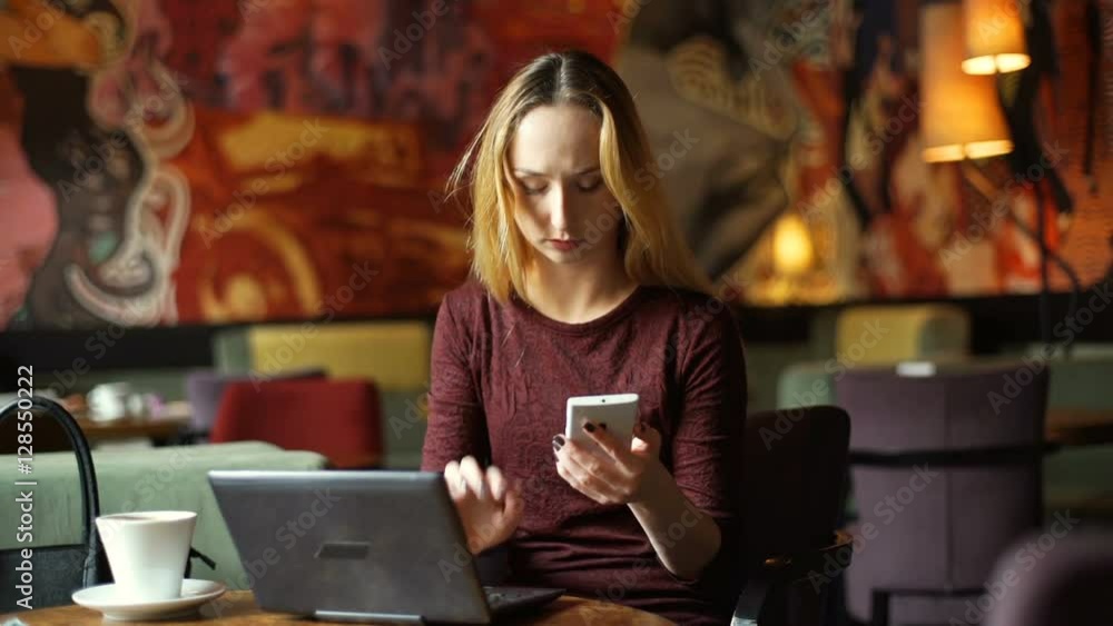 Occupied girl using modern technology in the cafe and drinking coffee
Occupied girl using modern technology in the cafe and drinking coffee