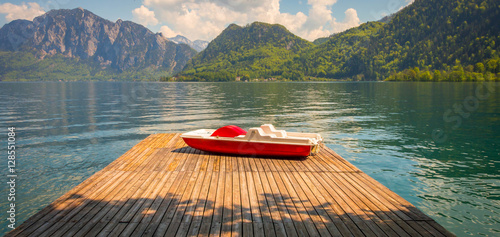 Lake in Austria, Salzburg, with Alps and red Boat