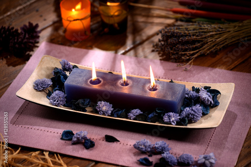 Aromatic lavender candle with violet sola flowers photo