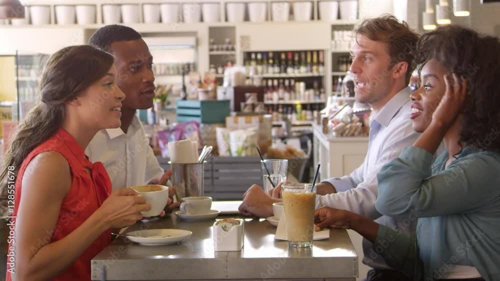 Group Of Friends Enjoying Drink In Cafe Shot On R3D Group Of Friends Enjoying Drink In Cafe Shot On R3D