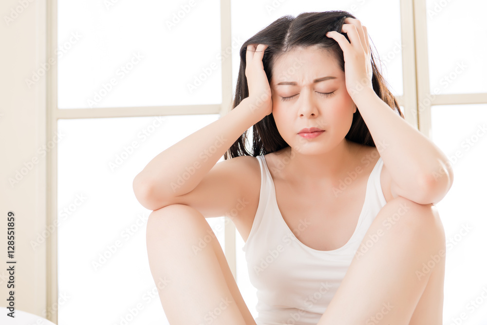 Beautiful asian woman suffering headache and massage forehead Beautiful asian woman suffering headache and massage forehead