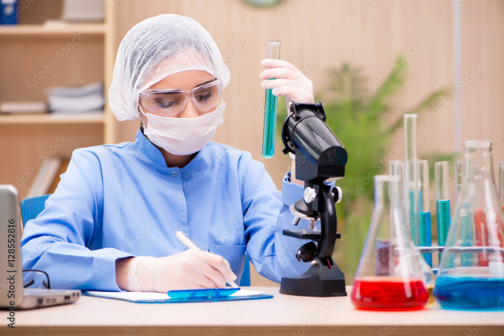 Lab chemist working with microscope and tubes Lab chemist working with microscope and tubes