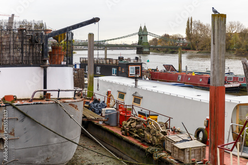 Old Hammersmith bridge on Thames, London photo