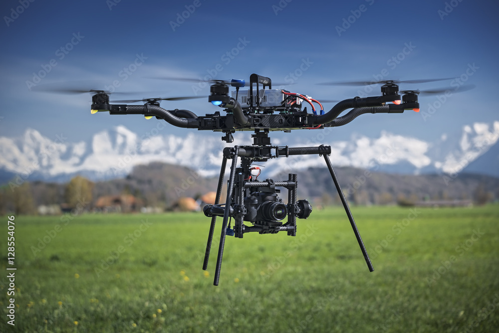 Big professional camera drone in mid-air. - obrazy, fototapety, plakaty 