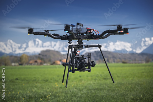 Big professional camera drone in mid-air.