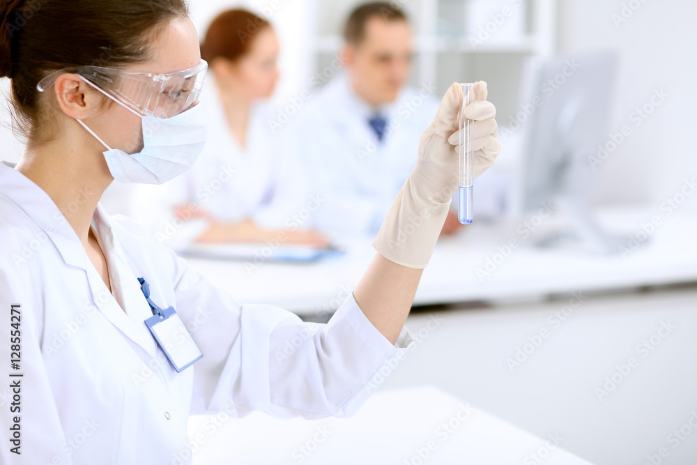 Scientific research team with clear solution in laboratory Scientific research team with clear solution in laboratory