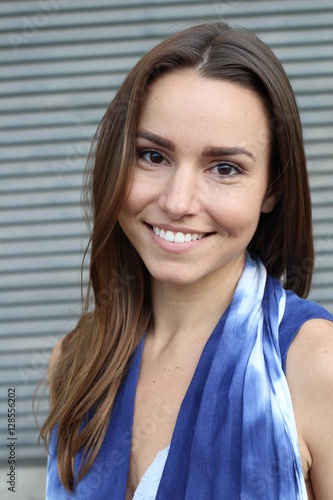 Beautiful woman in a blue dress smiling - Stock image