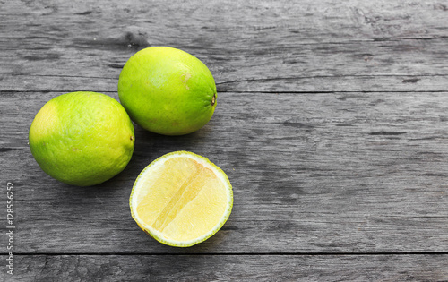closeup lemons on old wood background. over light [blur and select focus background]