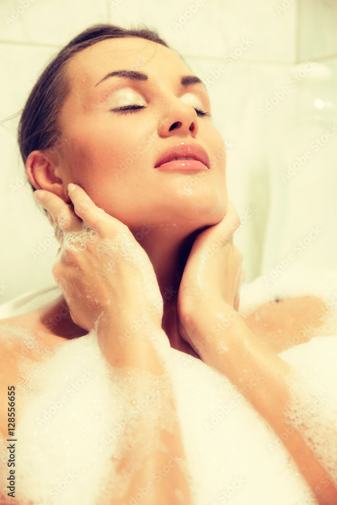 Young beautiful naked red-haired woman takes bubble bath Young beautiful naked red-haired woman takes bubble bath
